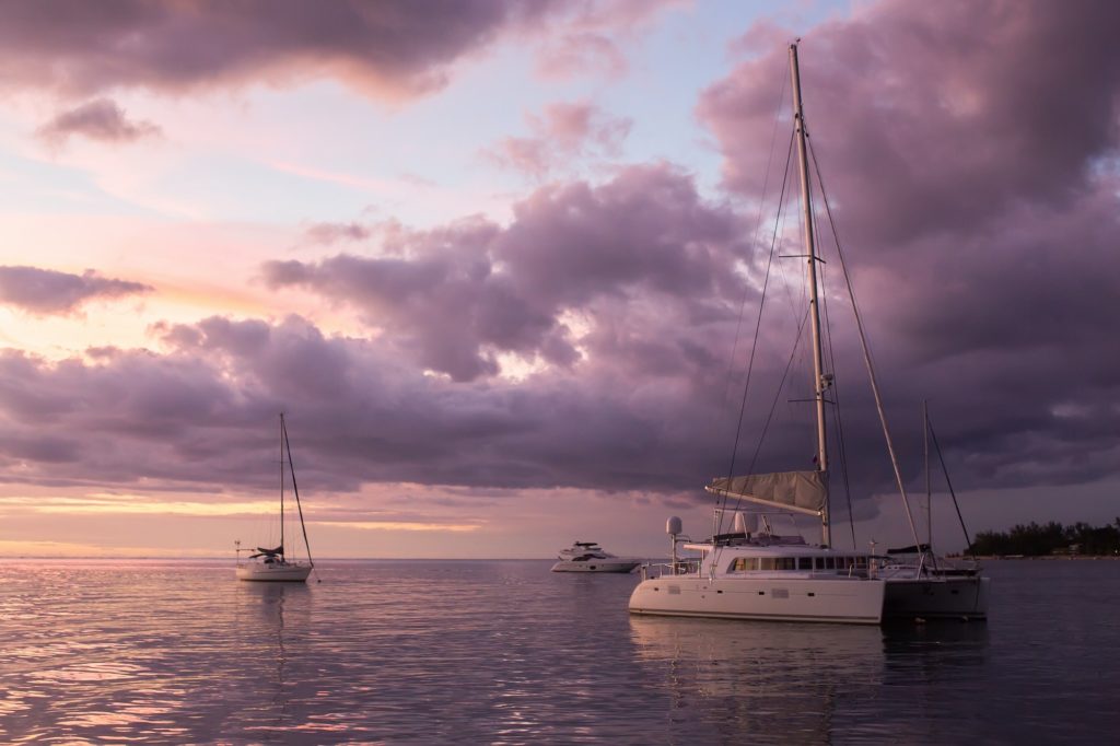 Catamaran yacht in the ocean at sunset