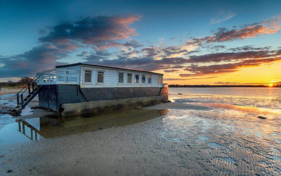 Dramatic sunset over a houseboat in Bramble Bush Bay