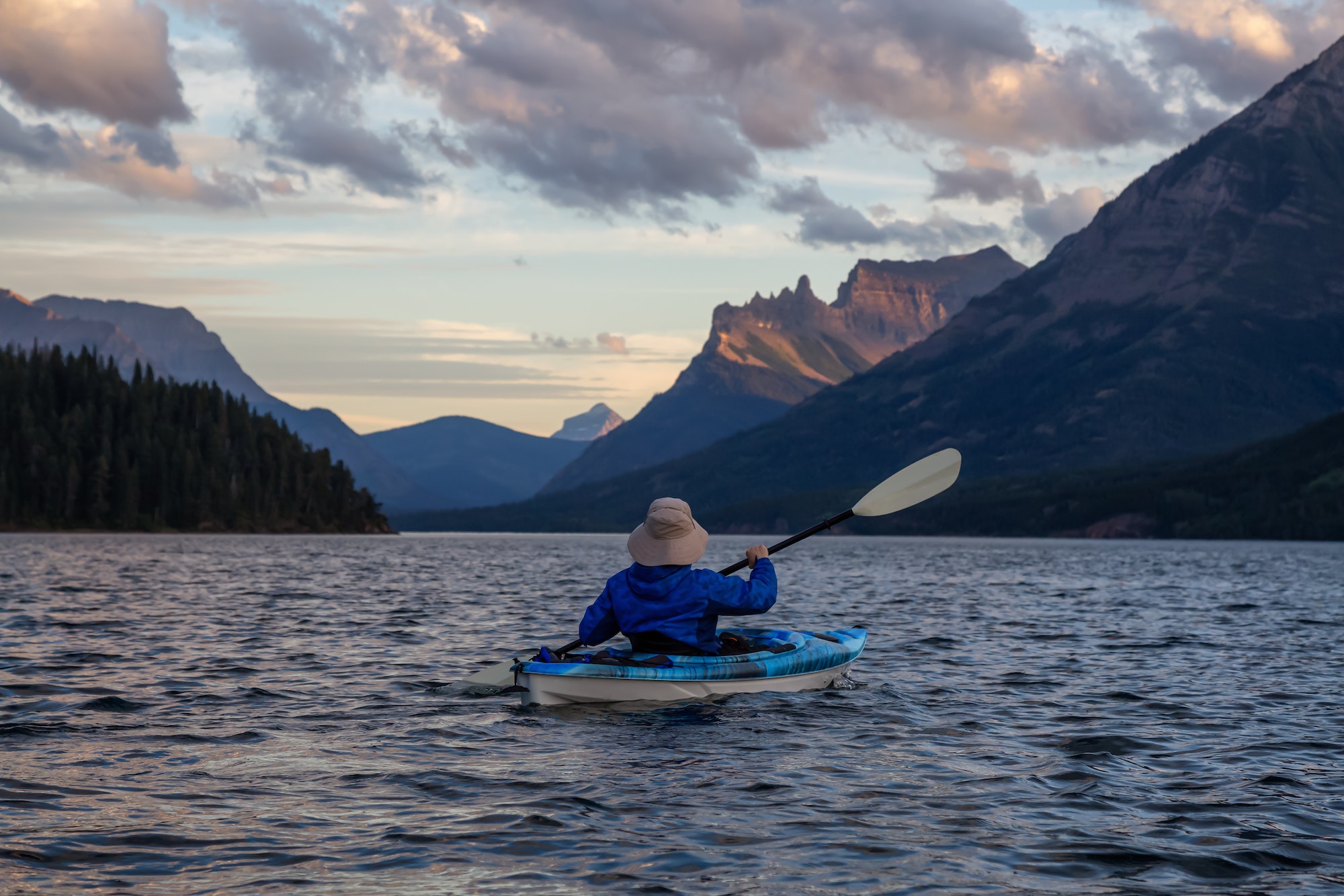 Kayaking in Glacier Lake surrounded by the Canadian Rocky Mountains