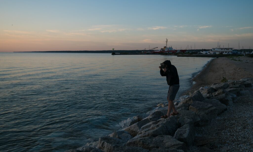 Film photographer documenting sunrise at Lake Huron in Northern Michigan.