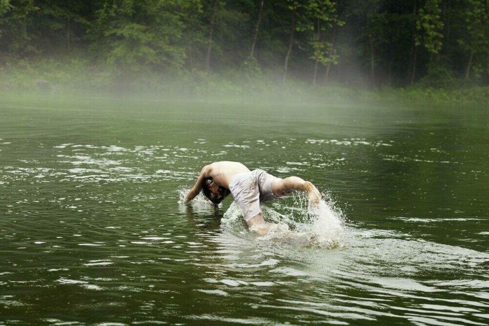 Man Swimming In Lake