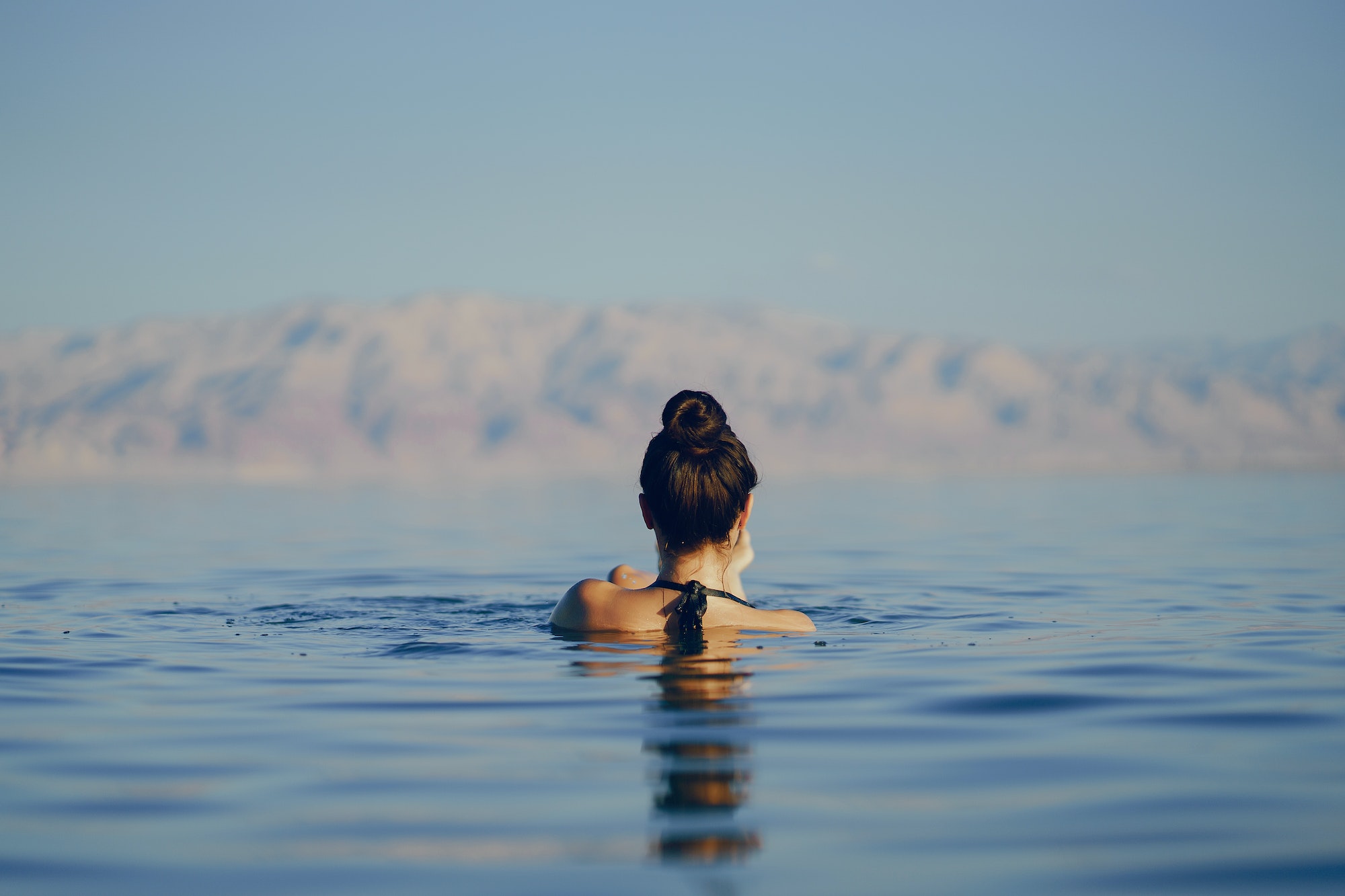 brunette girl swimming in the dead sea