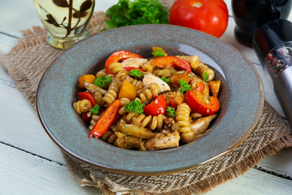 Pasta with fried chicken, mushrooms, pepper and pumpkin