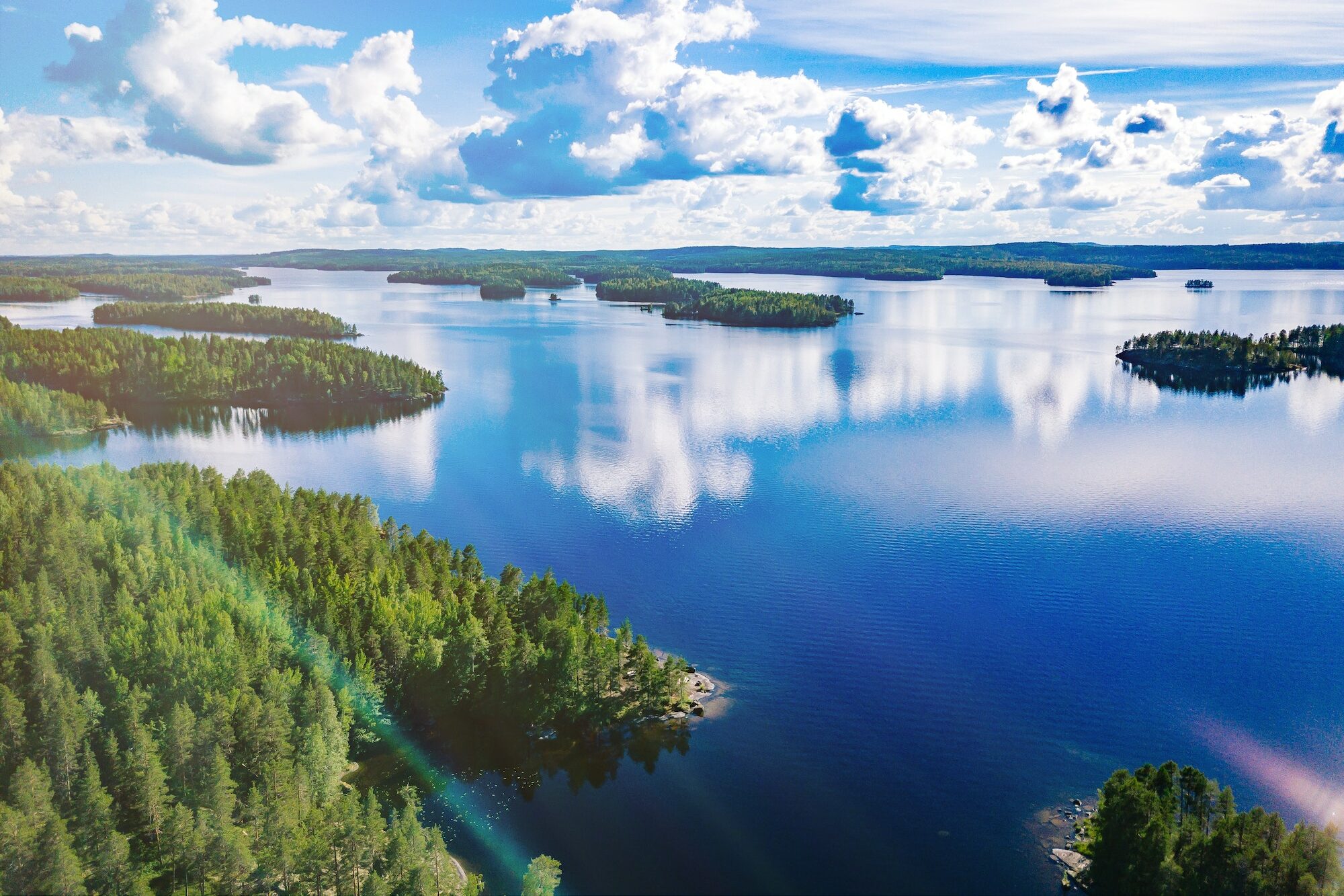 Aerial view of blue lakes and green woods in summer Finland.