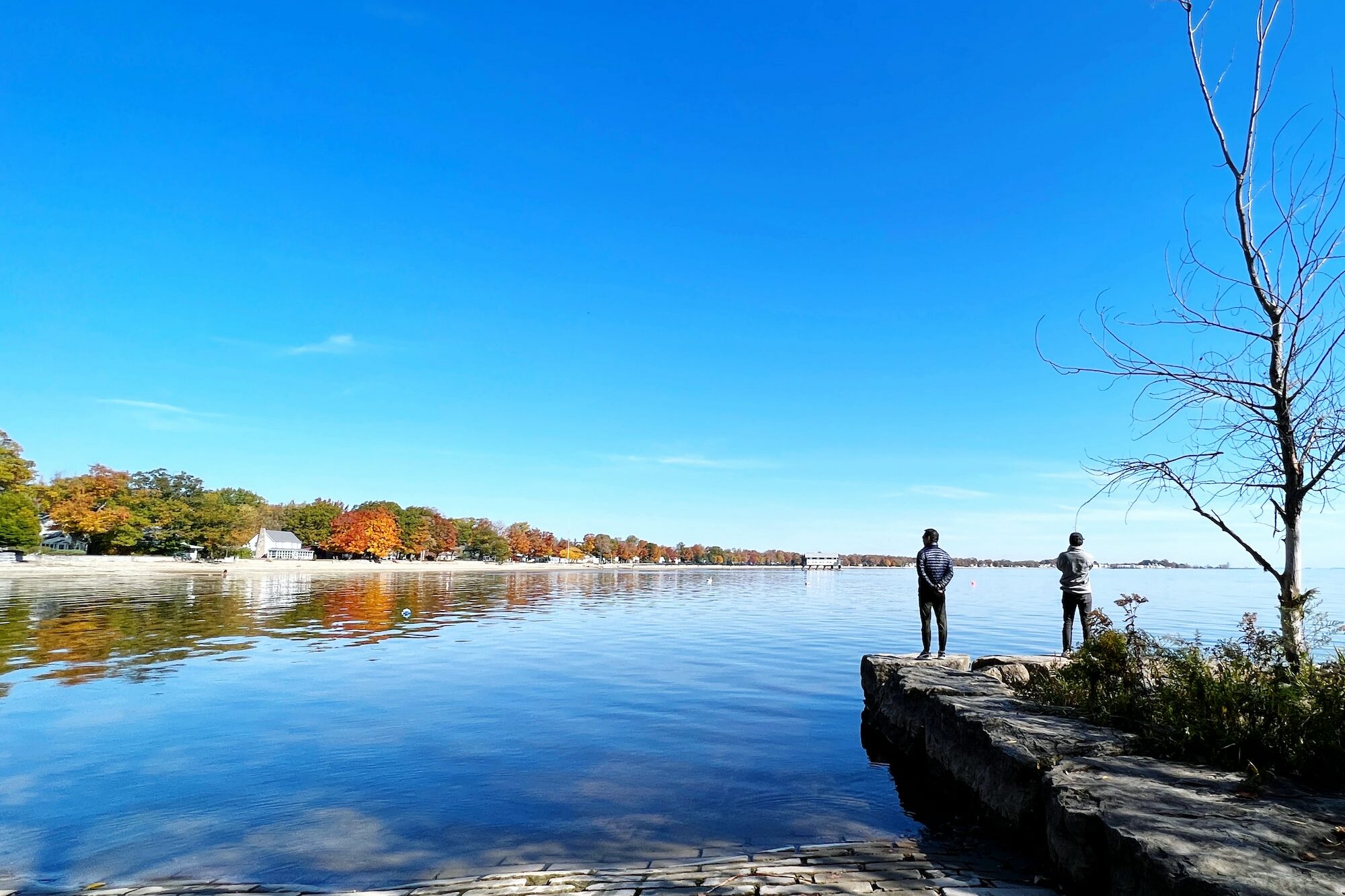 father and son enjoying serene Lake Erie autumn