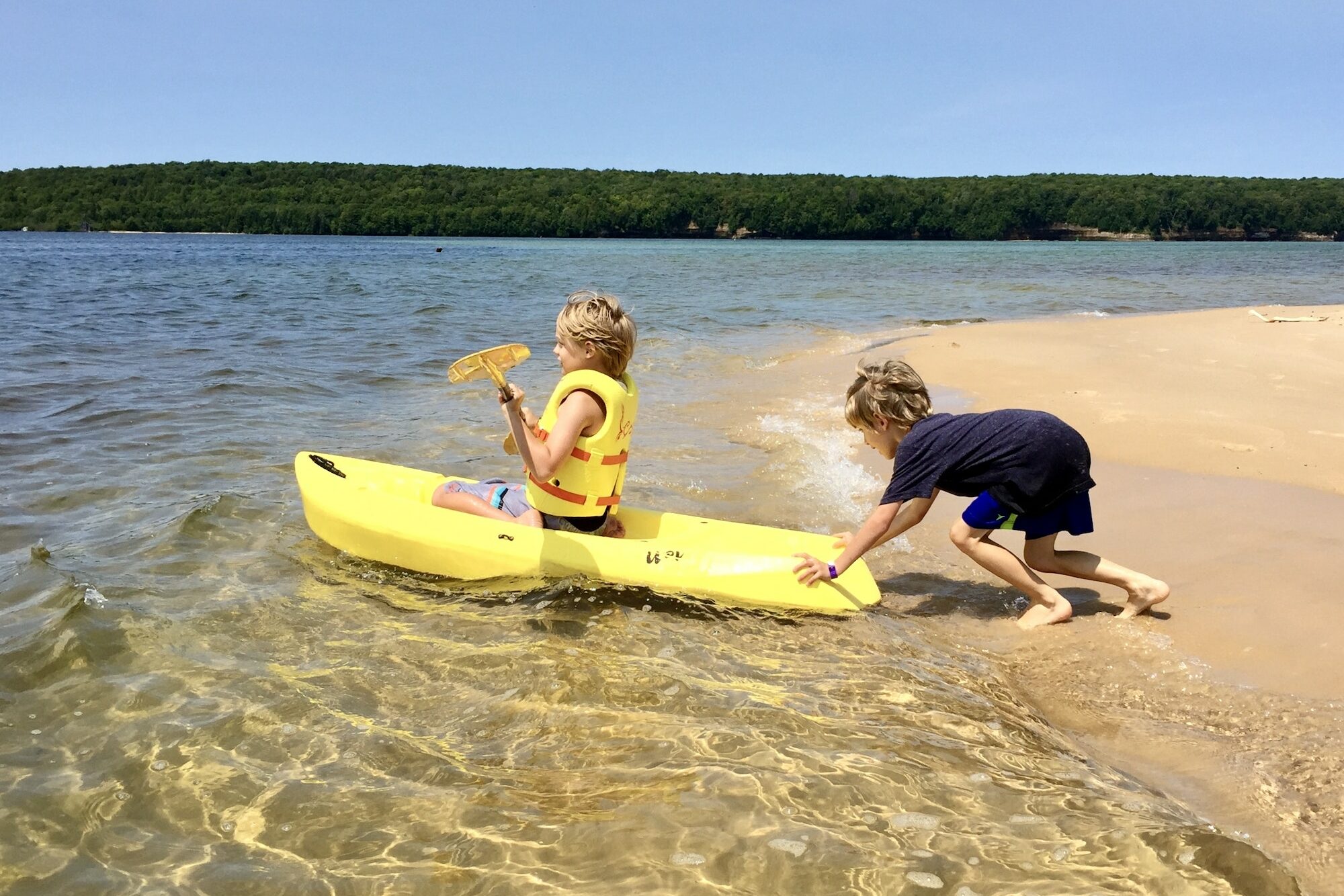 Lake Superior Kayaking - sibling helps out and gives the kayak a push into water