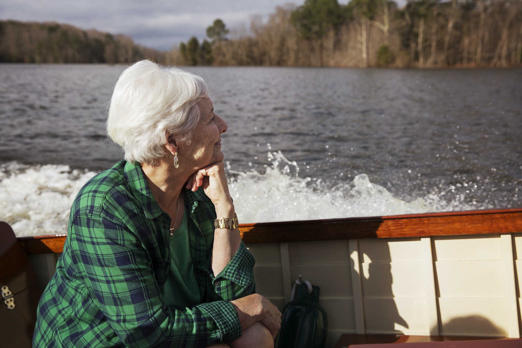 Senior Woman Sitting On Motor Boat