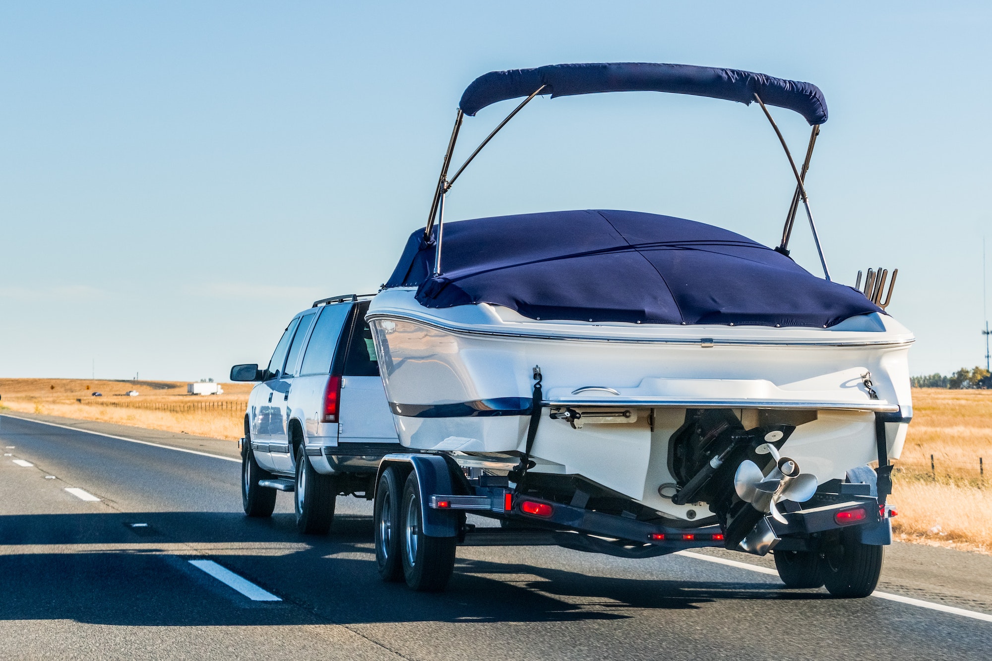 Truck towing a boat on the interstate, California