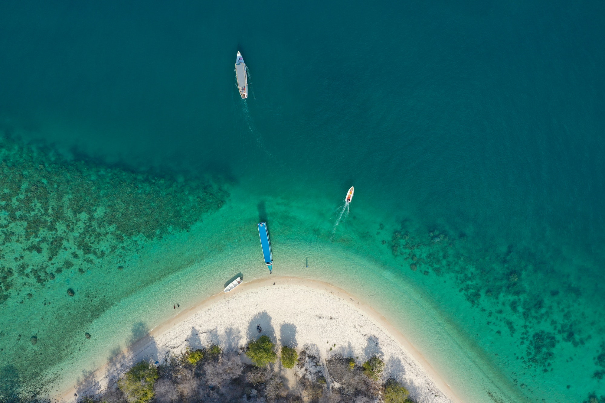 Aerial View of Island With White Sand and Boats