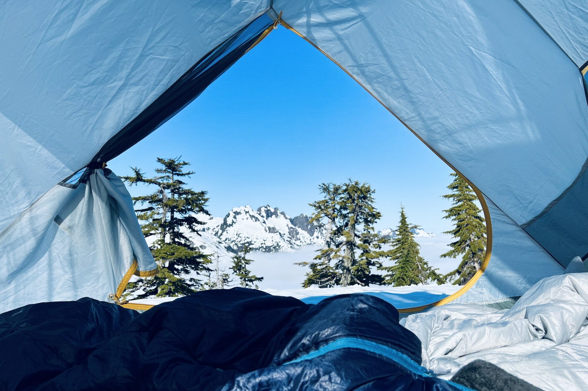 Camping in the snowy mountains above the cloud inversion