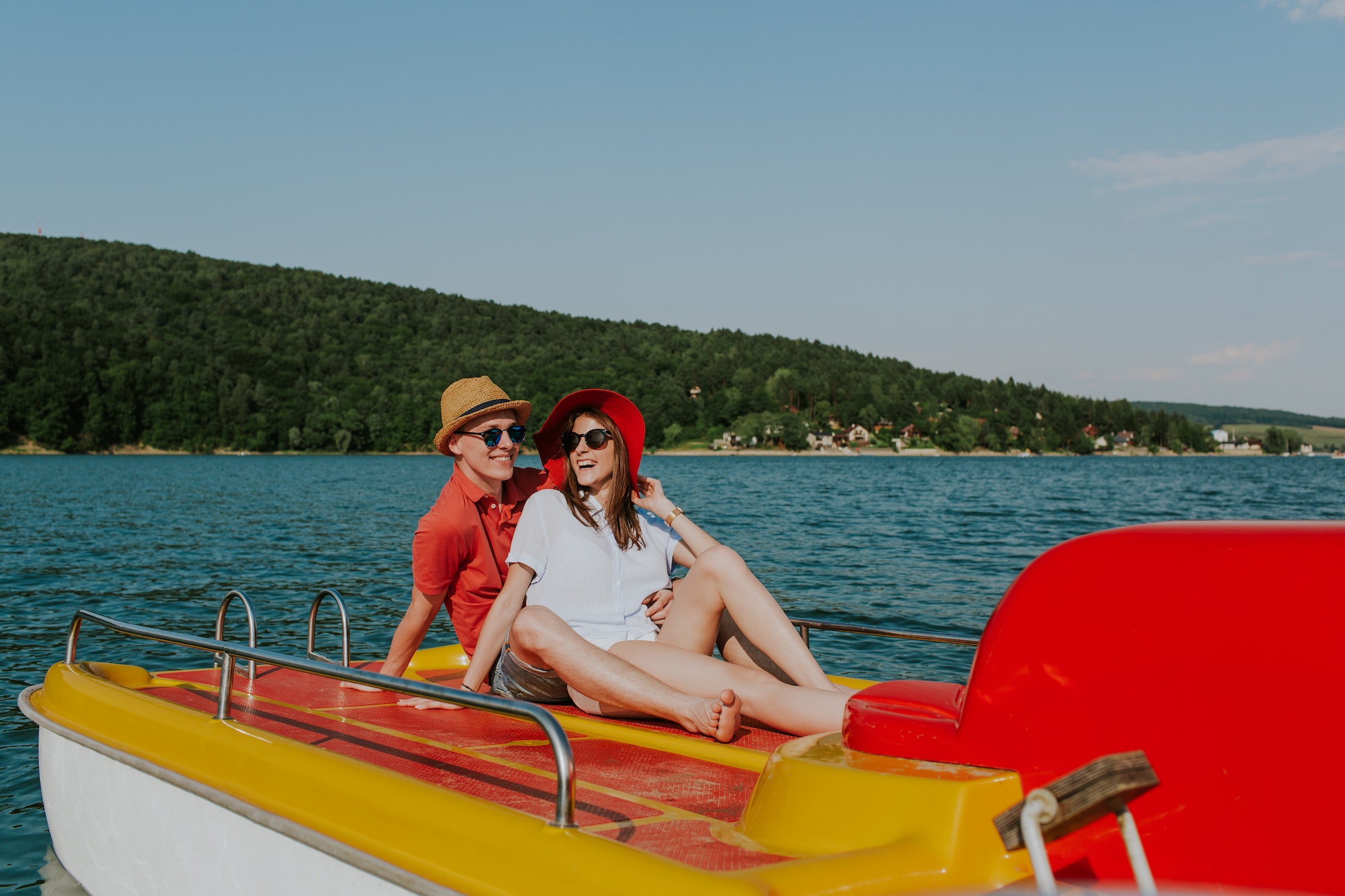 Cheerful man and woman having fun while boating.