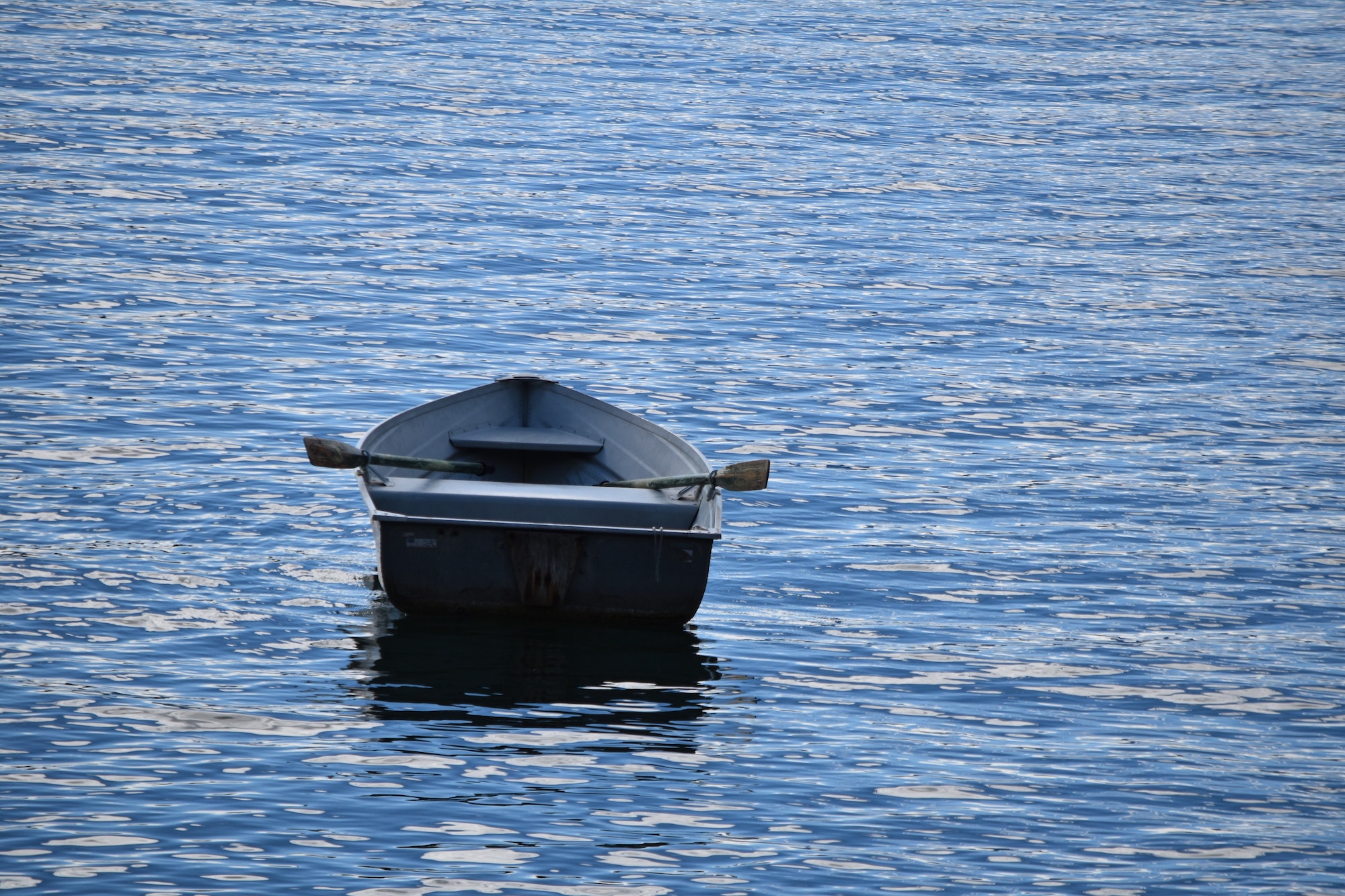 Empty rowboat in the middle of the sea