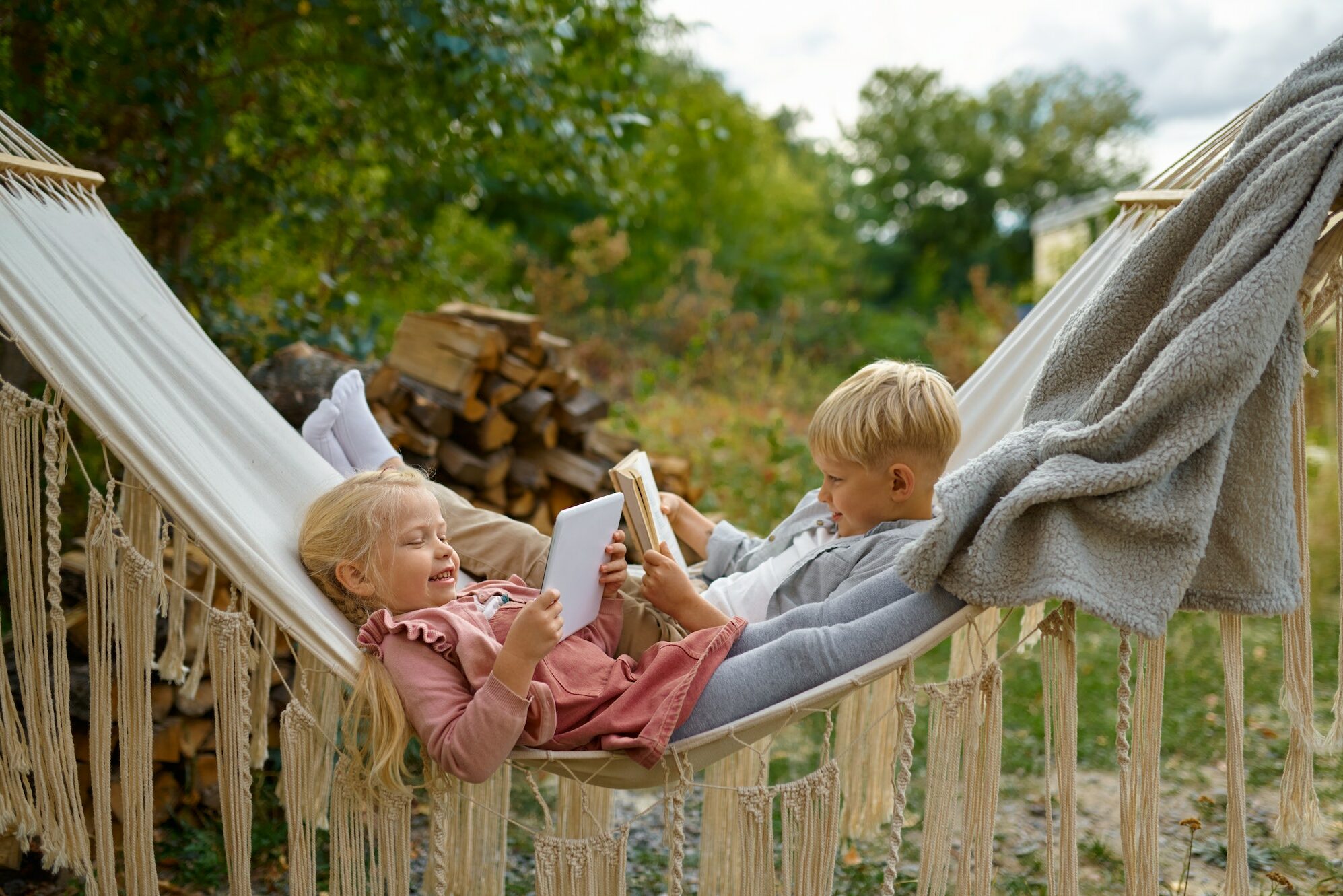 Funny kids lying in a hammock, summer camping