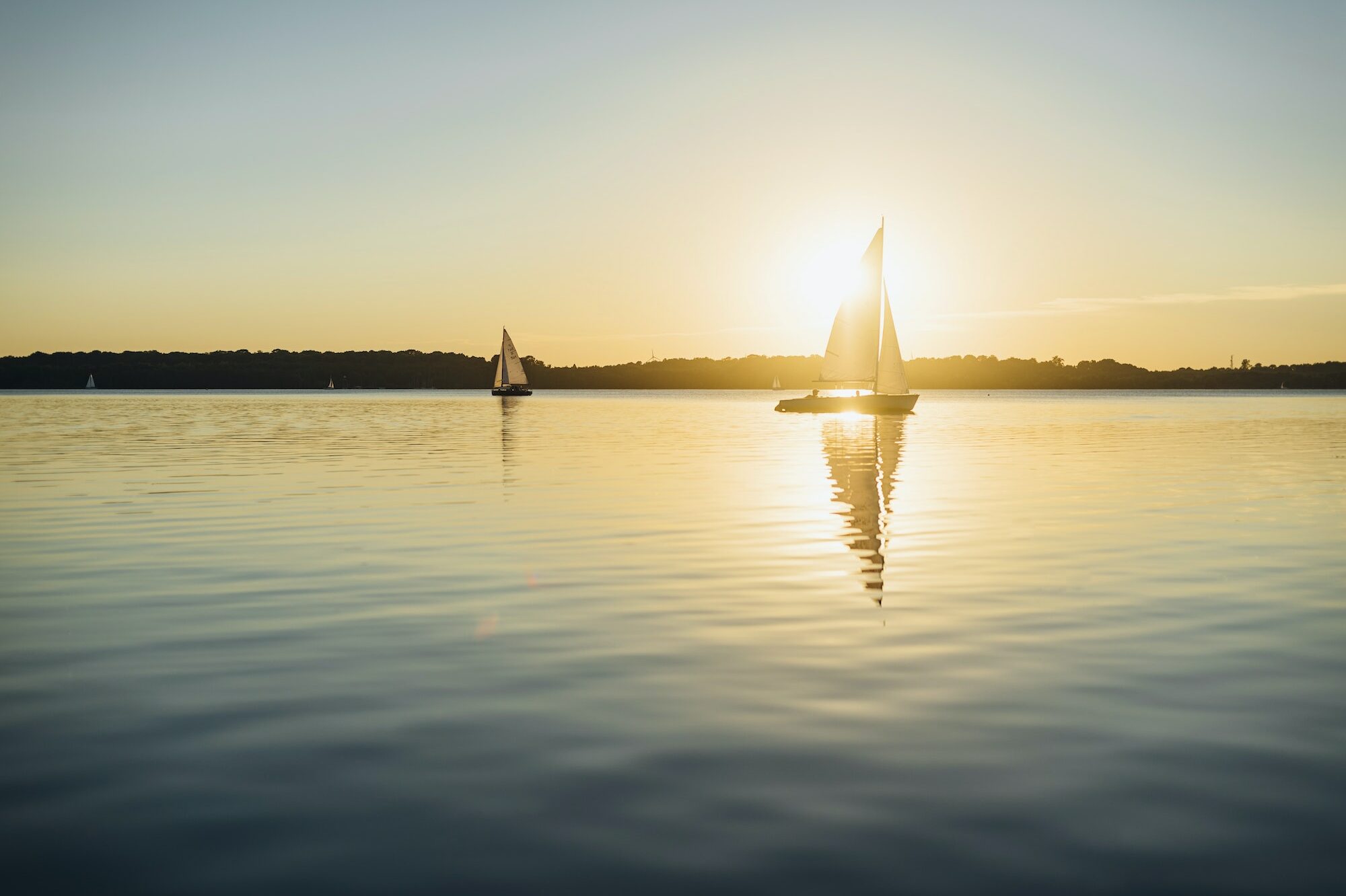 Sailing boat on Lake Cospuden at sunset