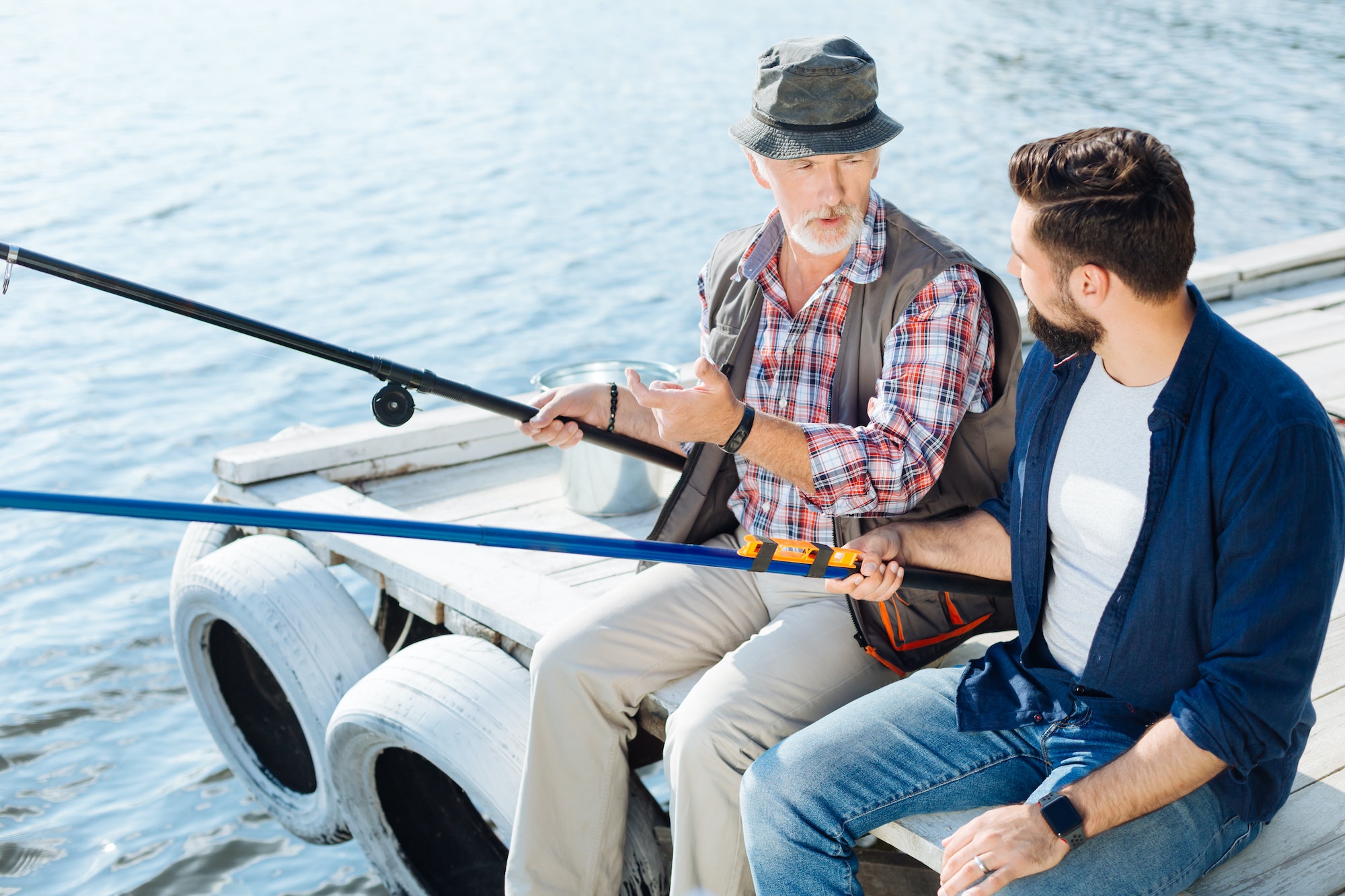 Young man spending weekend with mature male and fishing together