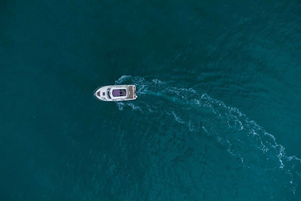 Aerial view of speed motor boat on open blue sea