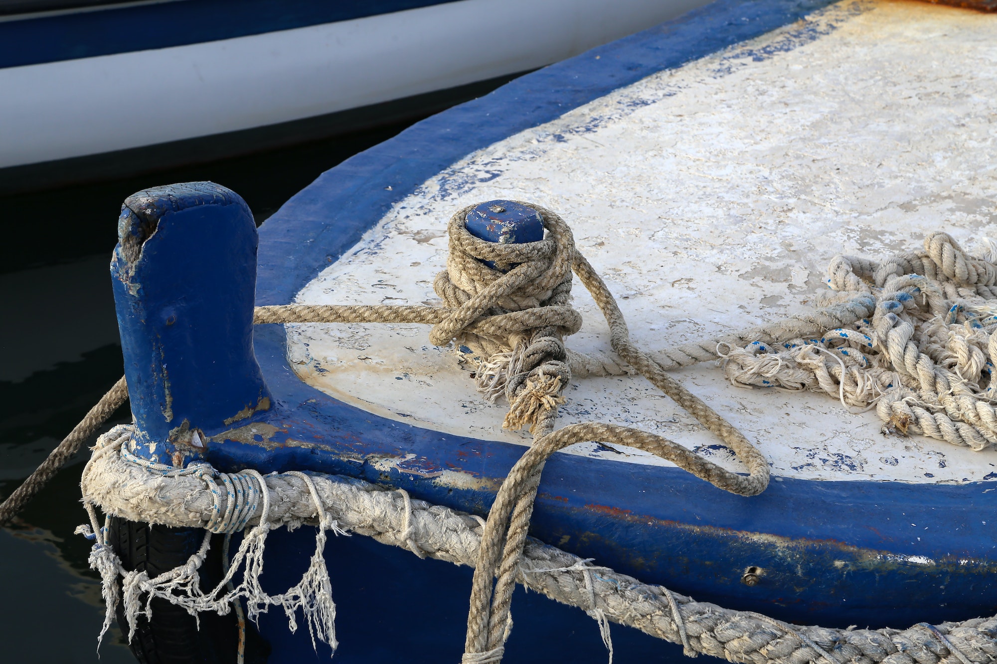 Old weathered rope for tying a boat on the pier